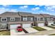 New construction townhomes featuring attached garages, neutral siding, brick accents, and well manicured lawns at 2792 Maricopa Blvd, Whitestown, IN 46075