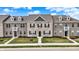 Charming brick townhomes with dormer windows and manicured lawns on a sunny day at 2792 Maricopa Blvd, Whitestown, IN 46075