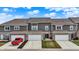 Close up aerial of gray townhouses with white trim, featuring individual garages and ample parking on paved driveways at 2792 Maricopa Blvd, Whitestown, IN 46075