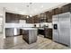 Modern kitchen with stainless steel appliances, dark wood cabinets, and an island that is great for entertaining at 2792 Maricopa Blvd, Whitestown, IN 46075