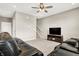 Relaxing living room with neutral walls, carpeted floors, and a ceiling fan with stairway access at 2792 Maricopa Blvd, Whitestown, IN 46075
