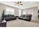 Spacious living room with neutral walls, ceiling fan, carpet, and two comfortable leather couches at 2792 Maricopa Blvd, Whitestown, IN 46075