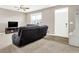 Inviting living room with neutral walls, carpet, a ceiling fan, and a view of the front door at 2792 Maricopa Blvd, Whitestown, IN 46075
