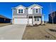 Charming two-story home featuring a stone facade, gray siding, well-manicured lawn, and a convenient two-car garage at 2976 W Tapestry Dr, Monrovia, IN 46157