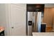 Kitchen area with stainless steel refrigerator and plenty of storage behind modern dark cabinets at 2976 W Tapestry Dr, Monrovia, IN 46157