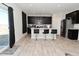 Modern kitchen with dark cabinets, a breakfast bar, stainless steel appliances, and bright lighting at 2976 W Tapestry Dr, Monrovia, IN 46157