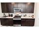 Spacious kitchen featuring dark cabinets, a stainless steel range, and stylish countertops for cooking enjoyment at 2976 W Tapestry Dr, Monrovia, IN 46157