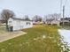 Large backyard with green grass and detached garage at 3016 Sheridan St, Anderson, IN 46016