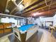 Finished basement with a pool table and exposed ceiling at 3016 Sheridan St, Anderson, IN 46016
