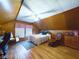 Spacious room with wood paneled walls, featuring hardwood floors, bed and a leather chair at 3016 Sheridan St, Anderson, IN 46016