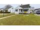 Inviting single-story home with neat landscaping and a cheerful yellow bench on the front porch at 3016 Sheridan St, Anderson, IN 46016