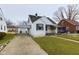 Traditional-style home with a carport and well-kept lawn, offering practical living with outdoor appeal at 3016 Sheridan St, Anderson, IN 46016