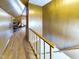 Hallway view of a room with wooden floors and walls, featuring a desk, chair, and a dormer window at 3016 Sheridan St, Anderson, IN 46016