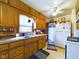 Traditional kitchen featuring wooden cabinets, a white refrigerator, and modern appliances at 3016 Sheridan St, Anderson, IN 46016