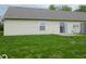 The backyard features a sliding glass door and a small patio with a grassy lawn at 306 Woodberry Dr, Danville, IN 46122