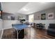 Finished basement with ping pong table, exercise equipment, and laminate wood flooring at 307 Blue Spruce Dr, Pendleton, IN 46064