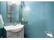 Powder room with blue walls, single sink, and a mirror at 307 Blue Spruce Dr, Pendleton, IN 46064