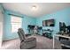 Bright blue bedroom equipped with gaming setup and comfortable seating at 307 Blue Spruce Dr, Pendleton, IN 46064
