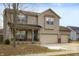 Inviting two-story home with a three-car garage and charming front porch, perfect for relaxing at 307 Blue Spruce Dr, Pendleton, IN 46064
