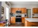 Functional kitchen featuring modern stainless steel appliances, oak cabinets, and ample countertop space at 307 Blue Spruce Dr, Pendleton, IN 46064