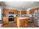 Well-equipped kitchen with oak cabinets, stainless steel appliances, and a functional kitchen island at 307 Blue Spruce Dr, Pendleton, IN 46064