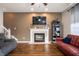 Inviting living room featuring a fireplace, hardwood floors, and comfortable seating arrangements at 307 Blue Spruce Dr, Pendleton, IN 46064