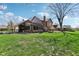 Home exterior with green lawn and trees, includes a screened porch and patio area at 3376 Scramble Dr, Greenwood, IN 46143
