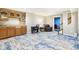 Inviting finished basement featuring modern flooring, wet bar, desk, and comfortable chair at 3376 Scramble Dr, Greenwood, IN 46143
