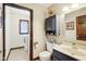Bathroom featuring vanity with solid surface countertop, medicine cabinet, and adjacent laundry area at 3376 Scramble Dr, Greenwood, IN 46143