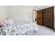 Cozy bedroom featuring a floral bedspread and a double door closet at 3376 Scramble Dr, Greenwood, IN 46143