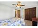 Cozy bedroom featuring a ceiling fan, closet, and comfortable bed with bright floral patterned comforter at 3376 Scramble Dr, Greenwood, IN 46143