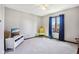 Neat bedroom with carpet floors, blue curtains, a white TV stand and a yellow chair at 3376 Scramble Dr, Greenwood, IN 46143
