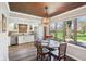 Bright dining room with wood-look floor, wood ceiling, bay window, and updated light fixture at 3376 Scramble Dr, Greenwood, IN 46143
