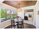 Bright dining room with wood-look floor, bay window, wood ceiling, and a view to the living room at 3376 Scramble Dr, Greenwood, IN 46143