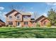 Charming two-story home with wood and brick exterior, manicured lawn and mature trees at 3376 Scramble Dr, Greenwood, IN 46143