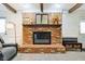 Close-up of a brick fireplace with a decorative mantel and hearth in the living room at 3376 Scramble Dr, Greenwood, IN 46143