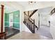 The home's stairs lead into a hallway which provides a view of the kitchen and entry way at 3376 Scramble Dr, Greenwood, IN 46143
