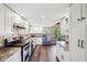 Bright kitchen boasts granite counters, stainless appliances, and wood-look flooring with ample storage at 3376 Scramble Dr, Greenwood, IN 46143