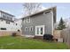 Back exterior featuring a well-maintained yard, a patio area, and stylish outdoor lighting at 4317 N Park Ave, Indianapolis, IN 46205