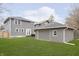 Spacious backyard featuring a detached garage and patio doors leading into the house at 4317 N Park Ave, Indianapolis, IN 46205