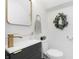 Chic bathroom with a modern vanity, gold fixtures, and a decorative wreath, creating a stylish space at 4317 N Park Ave, Indianapolis, IN 46205