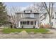 Charming two-story home featuring a covered front porch and professionally landscaped front yard at 4317 N Park Ave, Indianapolis, IN 46205