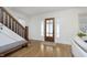 Bright foyer featuring hardwood floors, wooden staircase, and a beautiful front door at 4317 N Park Ave, Indianapolis, IN 46205