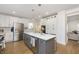 Bright kitchen featuring an island with a marble countertop, stainless steel appliances, and hardwood floors at 4317 N Park Ave, Indianapolis, IN 46205