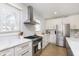 Modern kitchen featuring white cabinets, stainless steel appliances, subway tile backsplash, and a large window at 4317 N Park Ave, Indianapolis, IN 46205