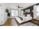 Cozy bedroom with a decorative rug, a ceiling fan, a large window, and stylish decor at 4317 N Park Ave, Indianapolis, IN 46205
