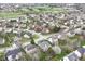 Expansive aerial view of a residential neighborhood with lush green lawns and mature trees, with golf course in the background at 5300 Breakers Way, Carmel, IN 46033