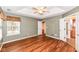 Large bedroom featuring wood floors, a window, with views into the ensuite bath and walk-in closet at 5300 Breakers Way, Carmel, IN 46033