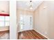 Inviting foyer with hardwood floors, a white front door with sidelights, and neutral paint at 5300 Breakers Way, Carmel, IN 46033