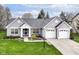 Charming home with a well-manicured lawn, gray brick, three car garage, and beautiful landscaping at 5300 Breakers Way, Carmel, IN 46033